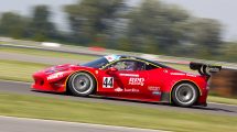 red racing car on race track during daytime